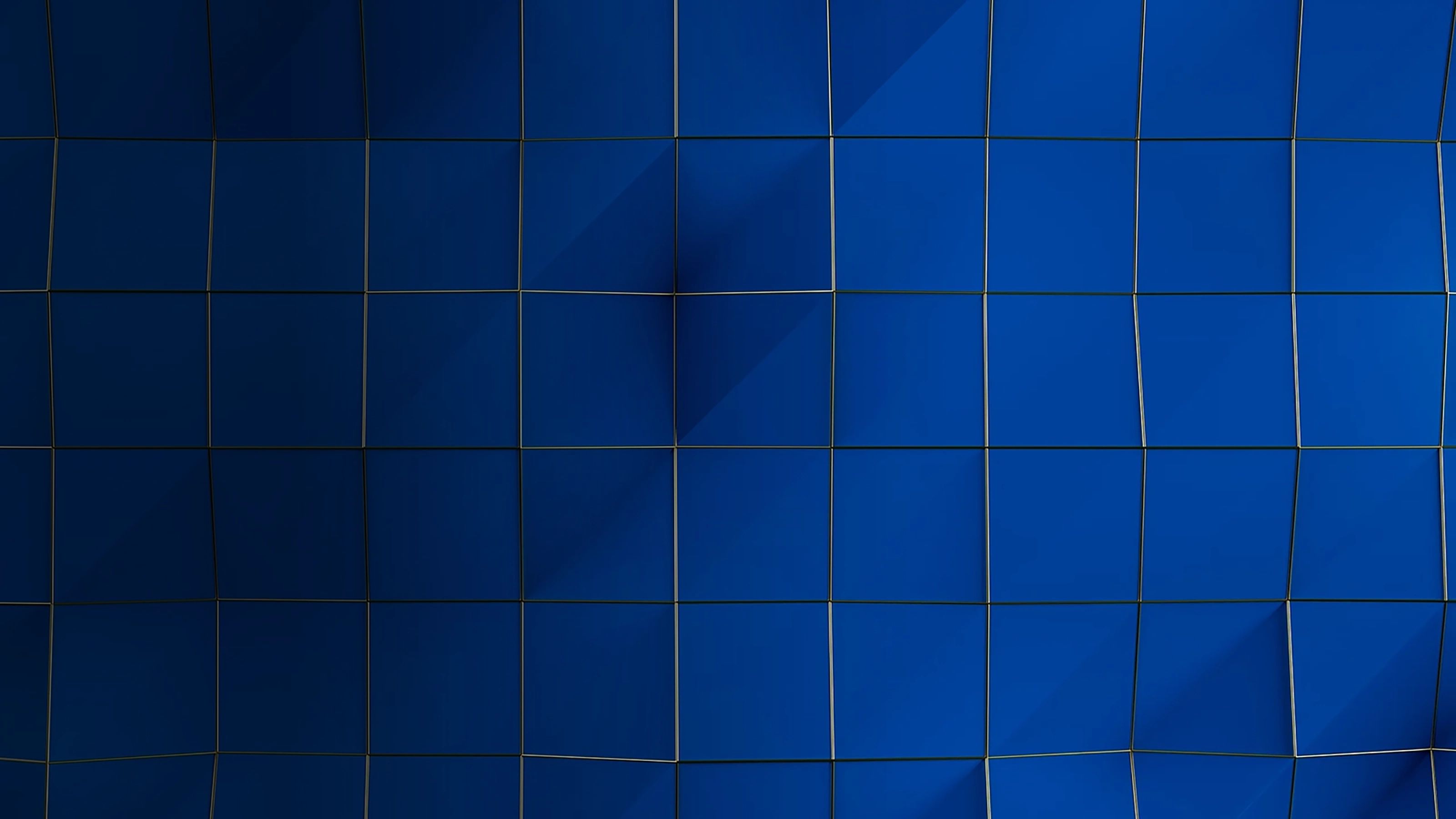 Blue grid of slightly distorted rectangular tiles with subtle shadows and curved vertical lines.