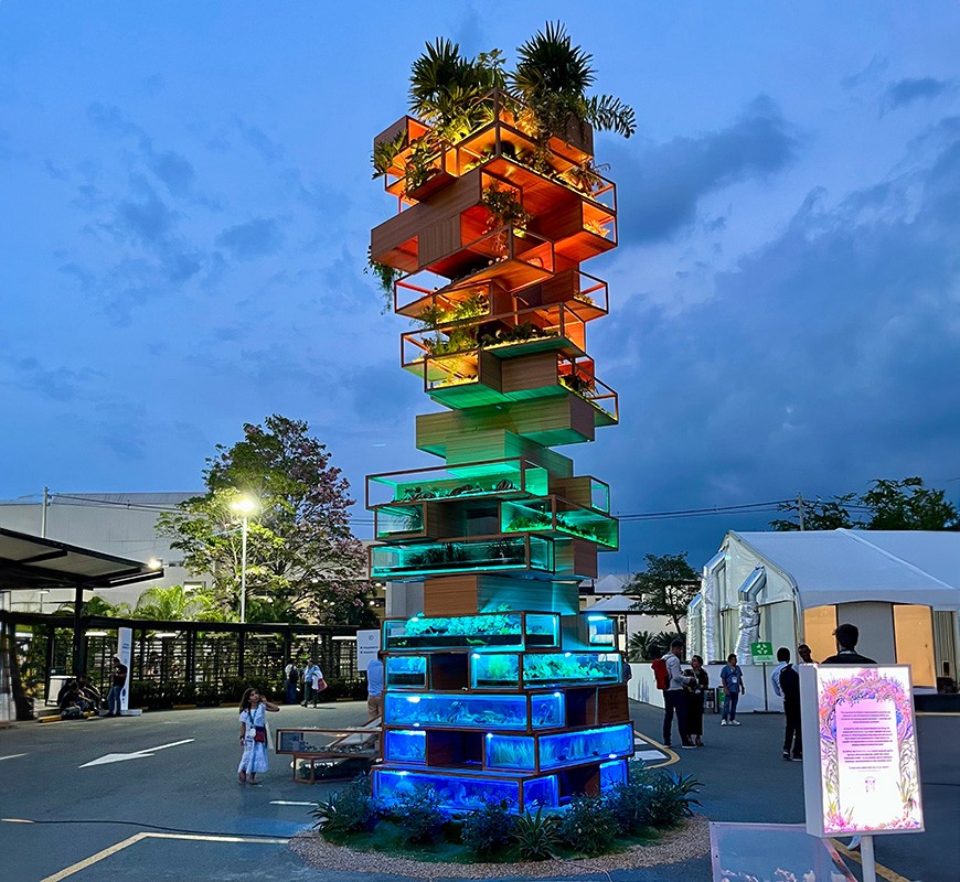 Biodiversity Jenga, created by Benjamin Von Wong, was a six-meter-tall installation at COP16 and highlights that biodiversity is like Jenga — interconnected, with each piece contributing to the whole's stability.