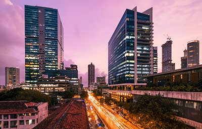 A breathtaking sunset over a modern city skyline, with skyscrapers silhouetted against a vibrant, colorful sky.